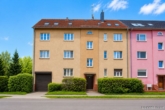Fassade - Gepflegtes Mehrfamilienhaus mit 7 Wohneinheiten, Garagen und zusätzlichem Baugrundstück