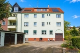 Hinterfassade - Gepflegtes Mehrfamilienhaus mit 7 Wohneinheiten, Garagen und zusätzlichem Baugrundstück